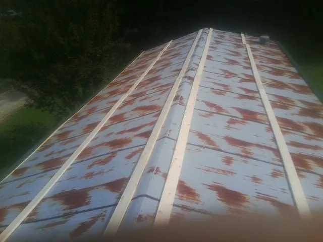 Rusted metal roof panels with new wood purlins before replacement — Storm Damage Roof Repair in Herscher by Roofing Brothers